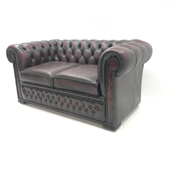 Two seat chesterfield sofa upholstered in deep buttoned ox blood leather, W155cm