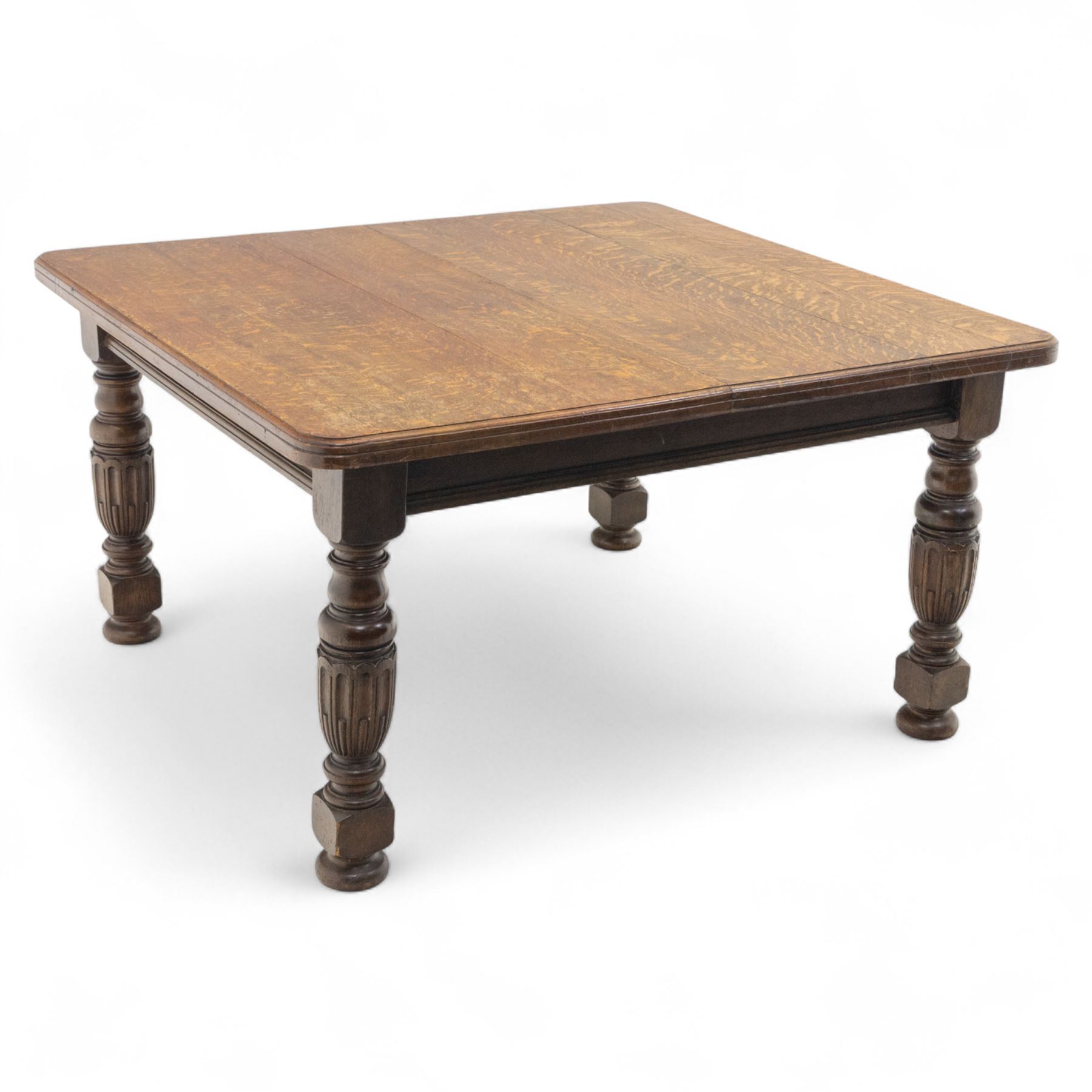 Victorian oak extending dining table, rectangular moulded top with figured grain pattern and wind-out action operated by removable crank handle, complete with additional leaves, raised on four boldly turned and reeded baluster supports terminating in squat bun feet (Extends to 238cm)