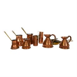 Copper and brass measures, including set of three copper jugs, set of four graduating bras...