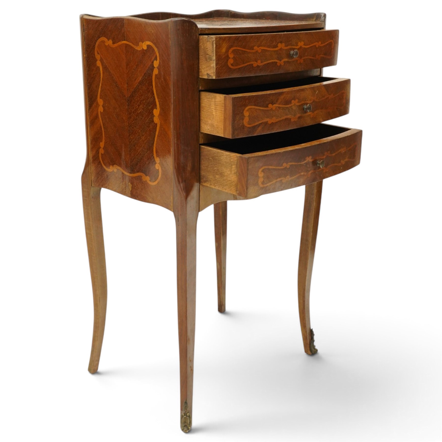 Matched pair of French inlaid floral marquetry bedsides, the three-quarter gallery tray top with central floral bouquet inlay and C-scroll border, one fitted with single frieze drawer over recessed cupboard and shaped apron, the other with three drawers, raised on tapering cabriole supports, with brass cartouche feet