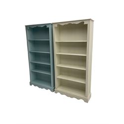 Pair painted pine open bookcases, shaped frieze over four shelves with reeded uprights, painted pale teal and cream  (2) 
