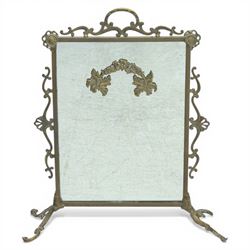 Mirrored brass firescreen, with scrolled frame on scrolled legs 
