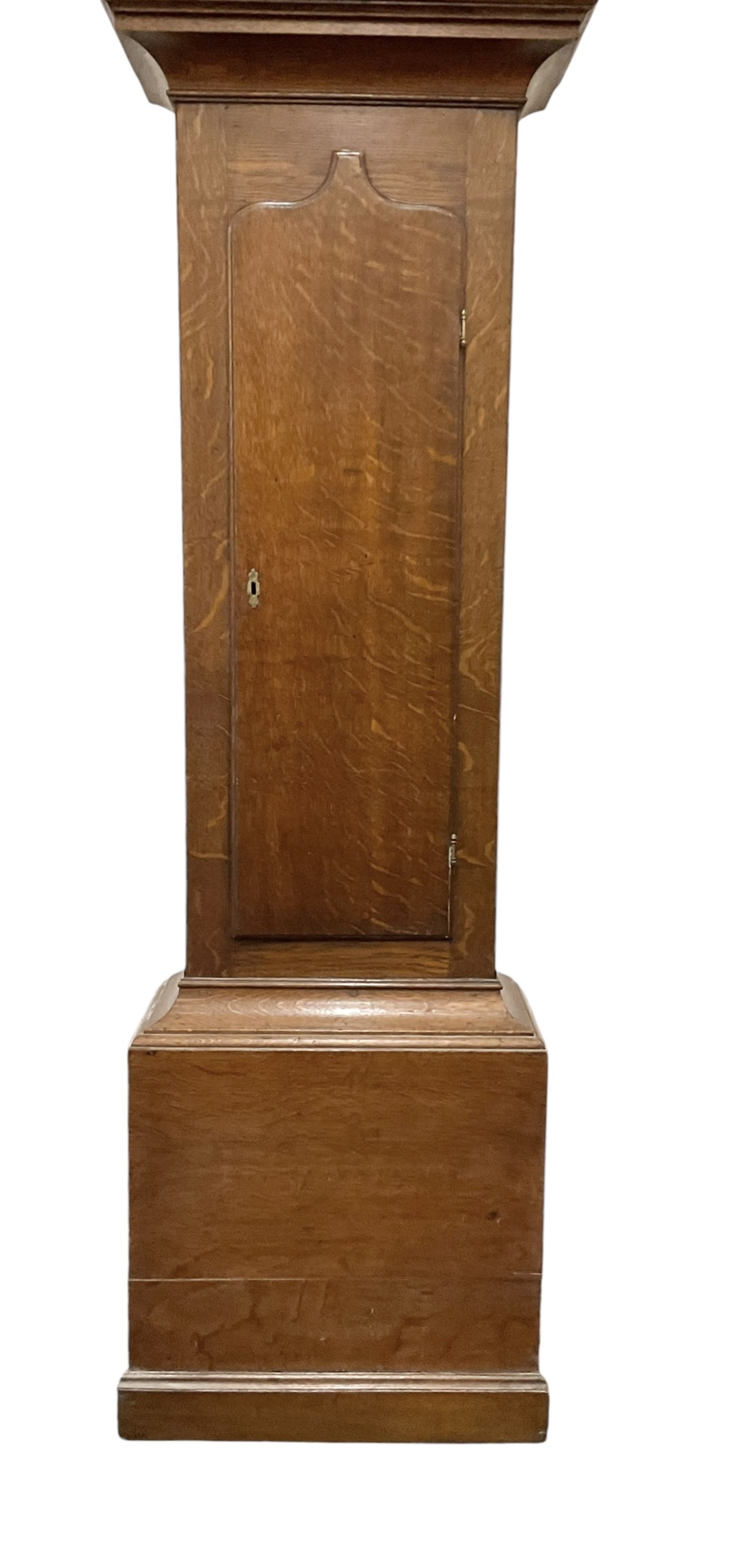 Early 19th century oak cased eight-day longcase clock c1810 - with a swan necked pediment and three matching brass finials, break arch hood door flanked by turned pilasters with brass capitals, trunk with a full length spire topped door on a square plinth with applied skirting, early painted dial with Roman numerals, Arabic five minutes, subsidiary seconds and date dials and steel hands, with floral spandrels and conforming decoration to the arch, dial pinned via a false plate to a rack striking movement, sounding the hours on a bell. With weights pendulum and key.