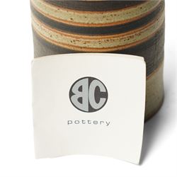 Sarah Butler and Martin Clark: Three works, comprising two bowls and a sleeve vase, each with incised potters mark to bases, and one with Heals mark, sleeve vase H24cm (3)