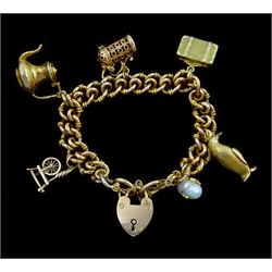 Early 20th century 9ct gold fancy double curb link chain bracelet, with heart locket clasp, five later 9ct gold charms including suitcase, tankard, penguin and spinning wheel and a 14ct gold pearl charm