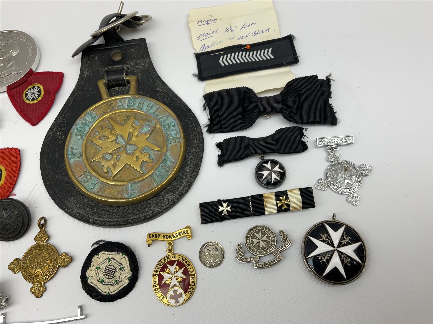 Collection of St John Ambulance enamel, metal and embroidered badges, together with St John Ambulance cadets sixty years medallion and a horse brass  