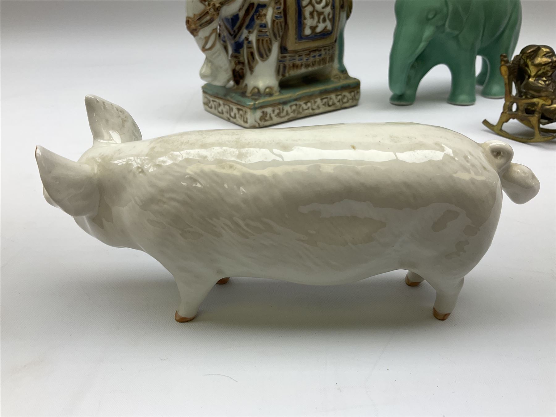 Beswick pig CH Wall CH Boy 53 figure, Priory Castings model of a seated pig, majolica ashtray in the form of an Indian elephant, elephant figure in green glaze and brass figures of pigs, Beswick pig L16cm