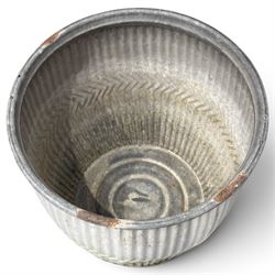 Two20th century galvanised metal dolly tubs, with rolled rims above corrugated bodies centred by chevron bands and circular bases, max W48cm H52cm)