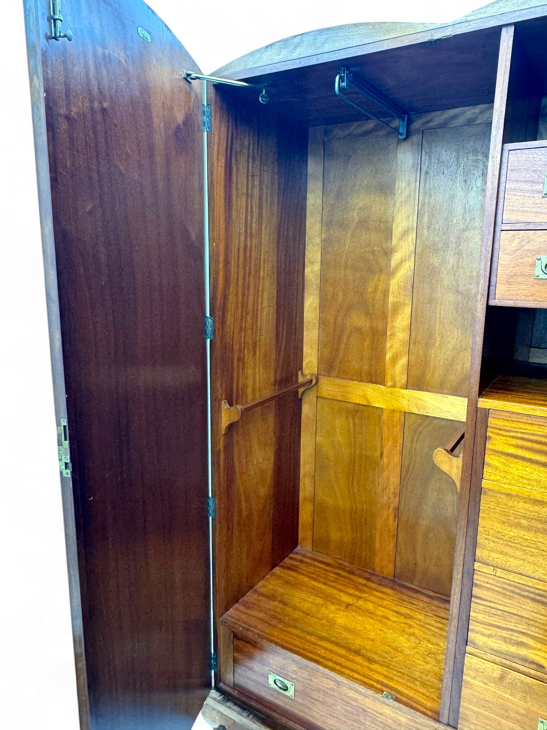 Ashton Leach & Cumberbirch Ltd., Rochdale - early 20th century walnut and mahogany gentleman's wardrobe, arched moulded top with book-matched figured walnut veneers, double doors enclosing fitted interior with hanging rail, tie rack and drawers, raised on cabriole supports