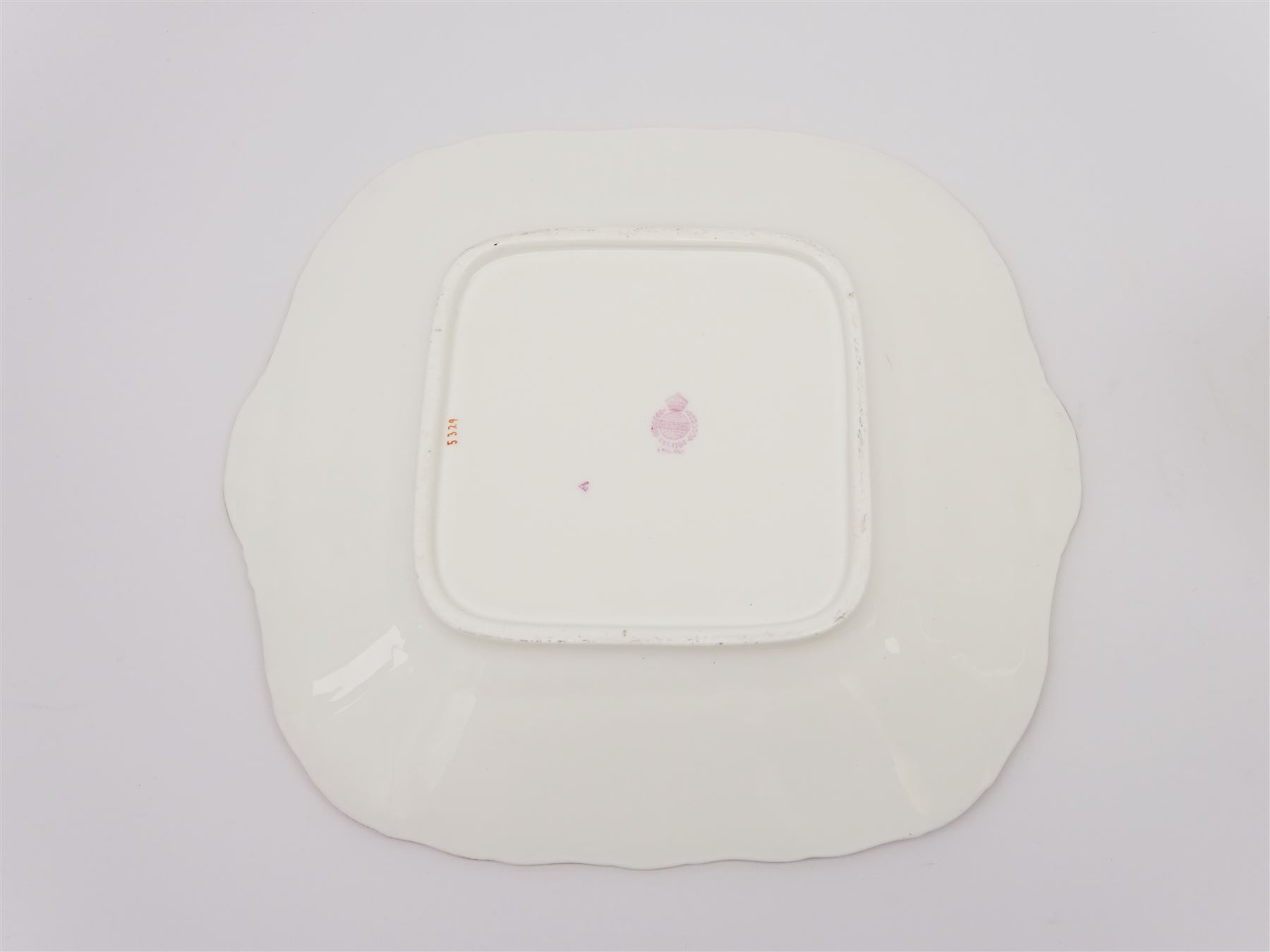 19th century Minton tea set, comprising twelve teacups, eleven saucers, fifteen side plates, cream jug, slop bowl, and two cake plates, decorated with panels of floral sprays, upon a green ground, heightened with gilt throughout, with printed puce mark beneath, and pattern number 5329
