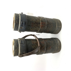 Pair of early 19th century ship's cannon charge carriers, each of ribbed tubular form, made from cork and covered with dark blue canvas bearing the Royal crest, one with leather carrying strap, H53cm (2)