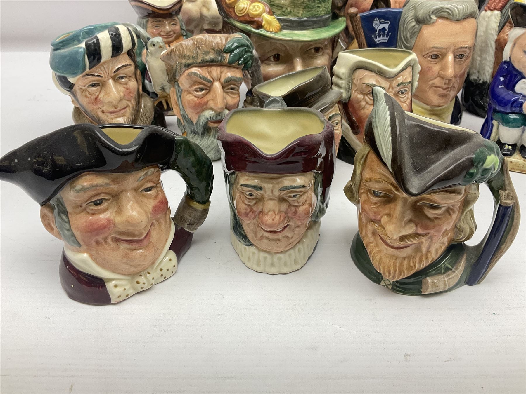 Collection of Royal Doulton and Beswick character jugs of various sizes, including North American Indian D6611, The Falconer D6533,  Tony Weller 281, Sairey Gamp 371 etc