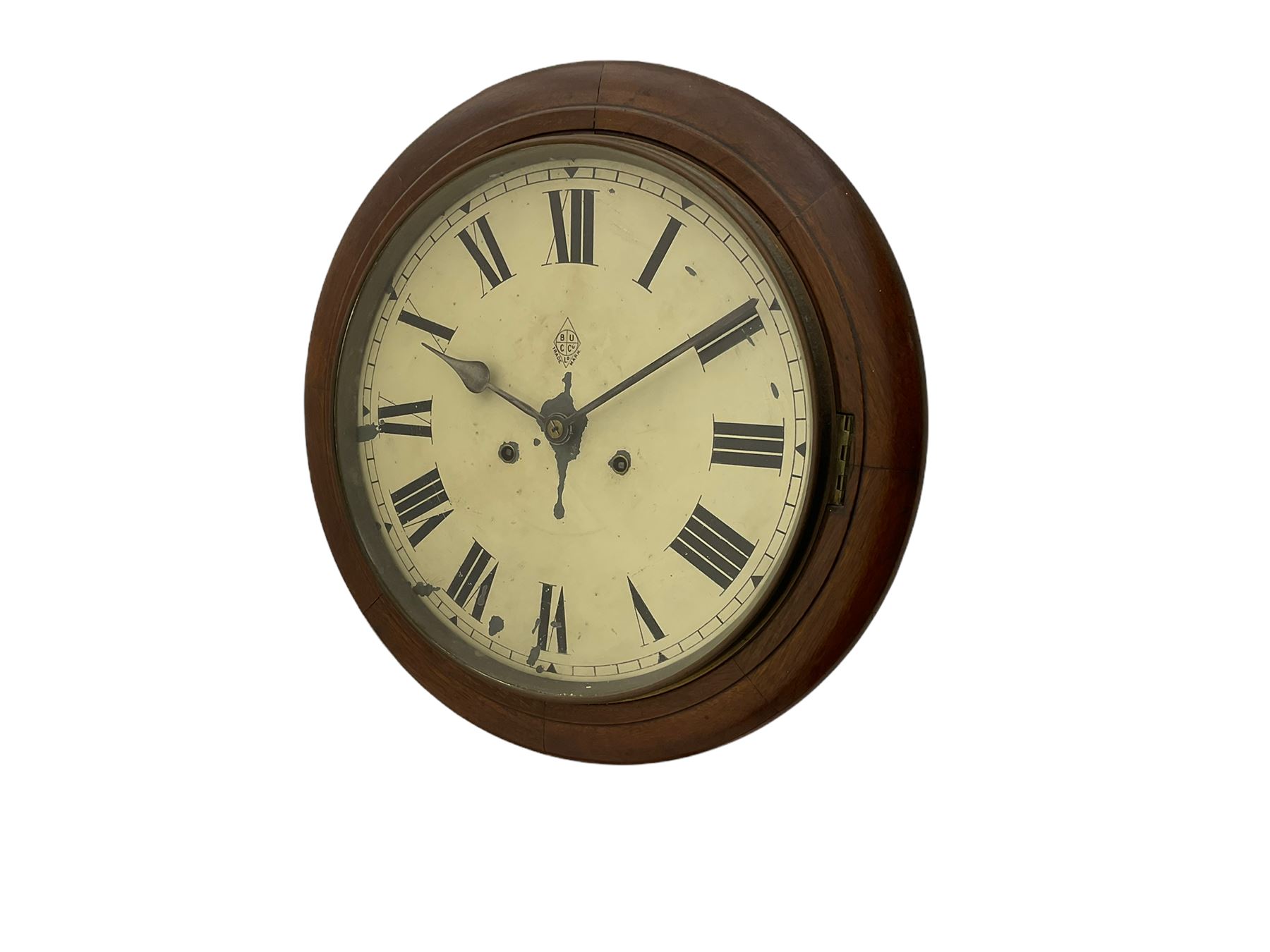 An early 20th century English wall clock with a circular 16” mahogany wooden bezel, 12” painted steel dial with Roman numerals and minute track, steel spade hands within a flat glass and spun brass bezel, eight-day rack-striking spring driven movement striking the hours on a coiled gong, with case side door and pendulum regulation door to base, dial inscribed with the trademark BUC Ltd . 
( British United Clock Company 1885-1909)
With pendulum and key.



