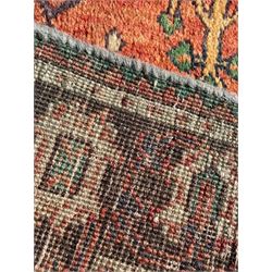 Persian Joshaghan rust ground rug, stepped lozenge medallion surrounded by repeating foliate lozenge motifs, the border decorated with stylised plant motifs, within geometric guard stripes
