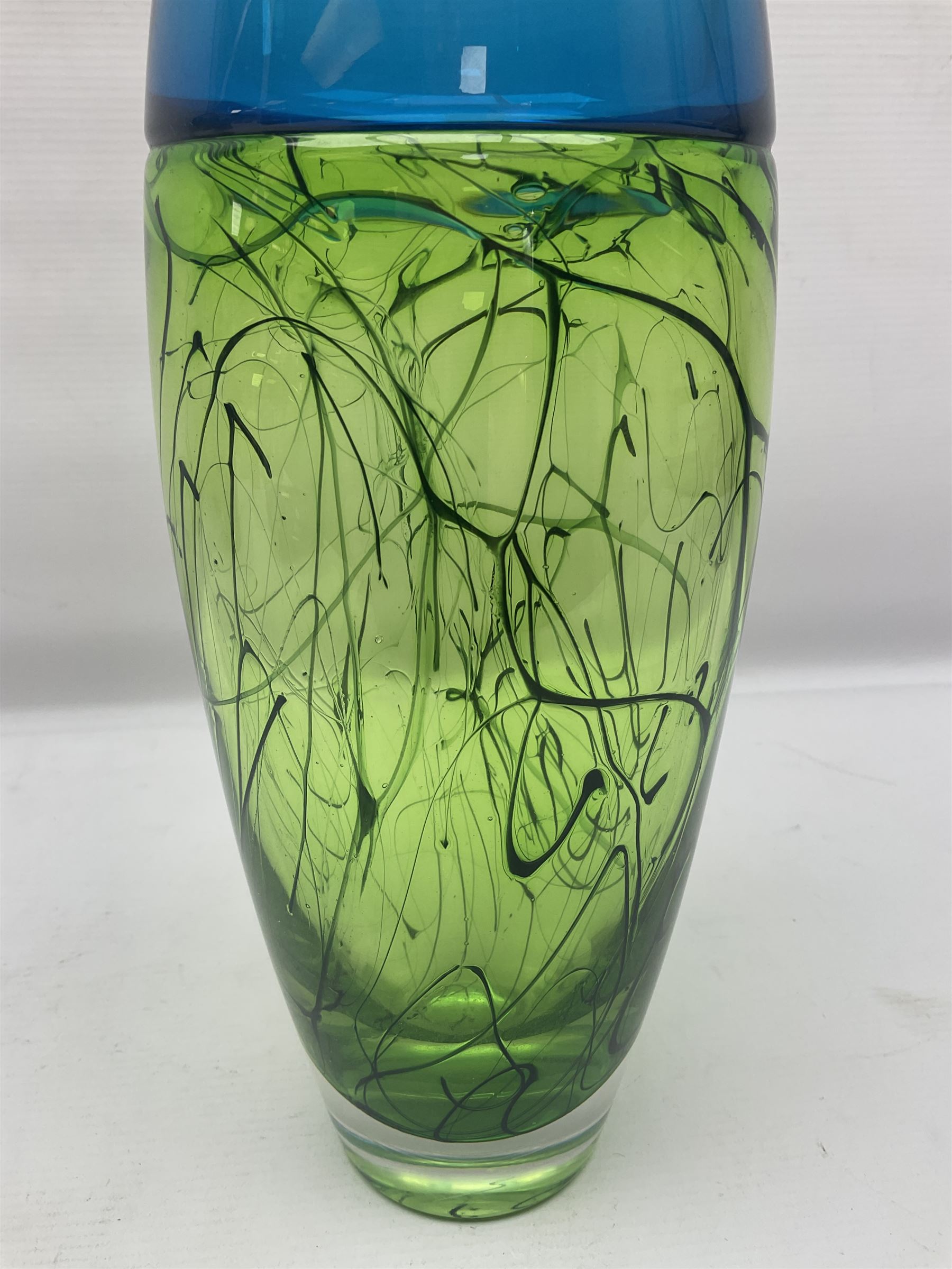 Stuart Akroyd glass vase, blue banded top and lime green lower section with free flowing line decoration, with sticker and engraved signature beneath, H29.5cm
