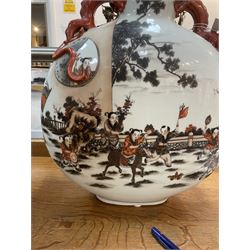 Chinese Republic period porcelain moon flask vase, of typical compressed spherical form, the neck and shoulders with applied iron red dragon handles, the body decorated in iron-red and grisaille with a 'one hundred children' design, depicting various children at play and engaged in musical pursuits within a garden setting, with apocryphal Qianlong mark beneath, H47cm