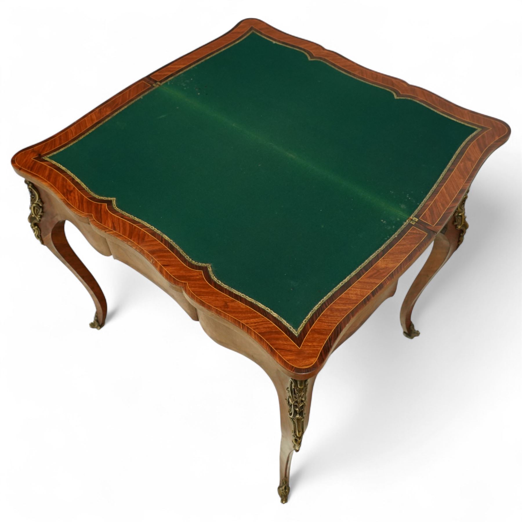 Early 20th-century Louis XV-style kingwood and tulipwood marquetry card table, shaped rectangular hinged top revealing baize-lined interior, with quarter-veneered parquetry within crossbanded borders and mounted with a gilt bronze edge, above a serpentine frieze,  raised on cabriole legs with gilt bronze foliate mounts and sabots 