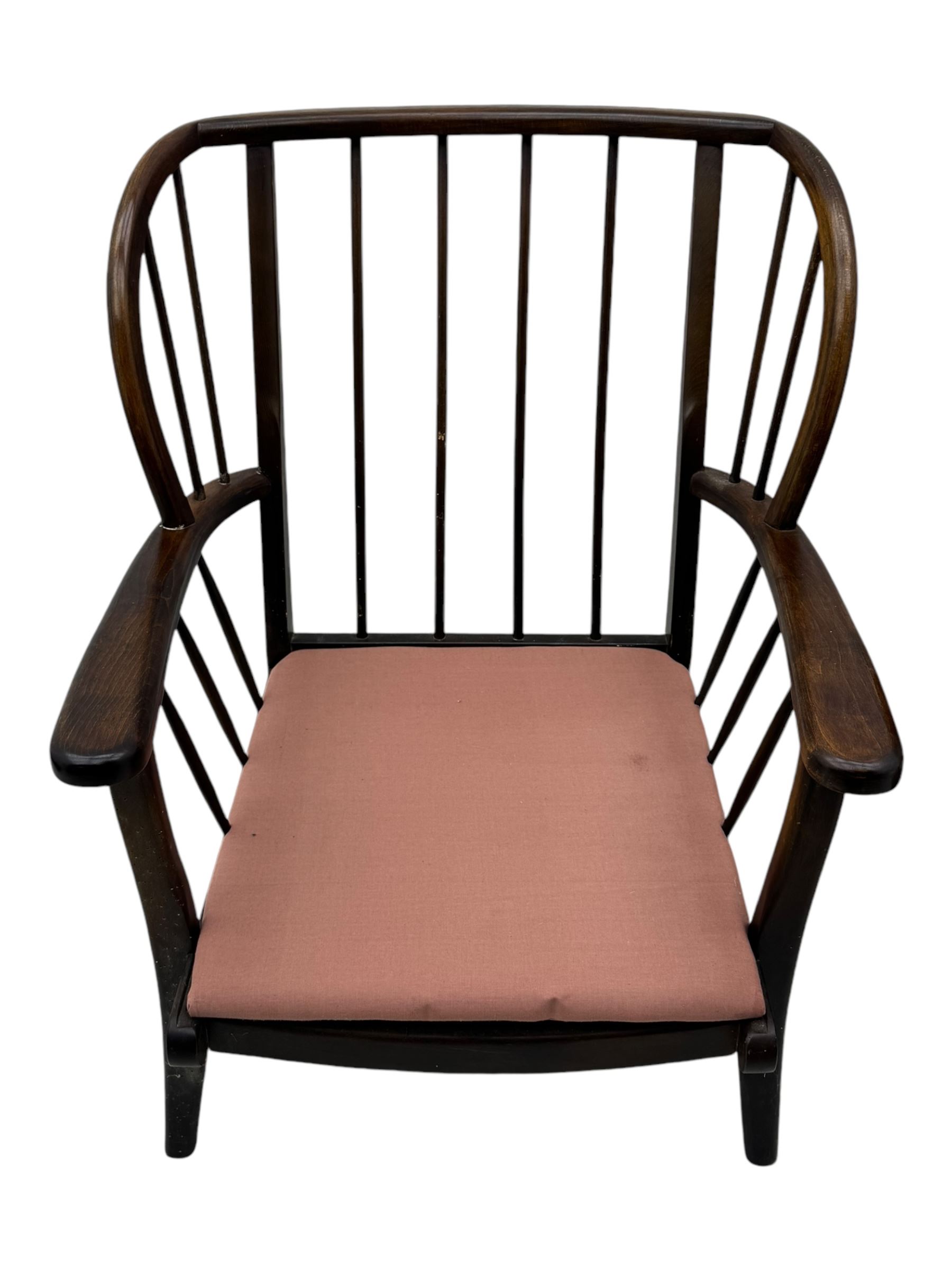 Joynson Holland - pair of mid-20th century stained beech framed easy chairs, shaped back and flat armrests over floral tapestry cushioned seat and back, on splayed supports united by stretcher