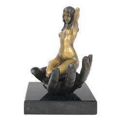 Nude In Hand bronze sculpture modeled as a female nude seated in a hand upon a marble base, signed June H24cm   