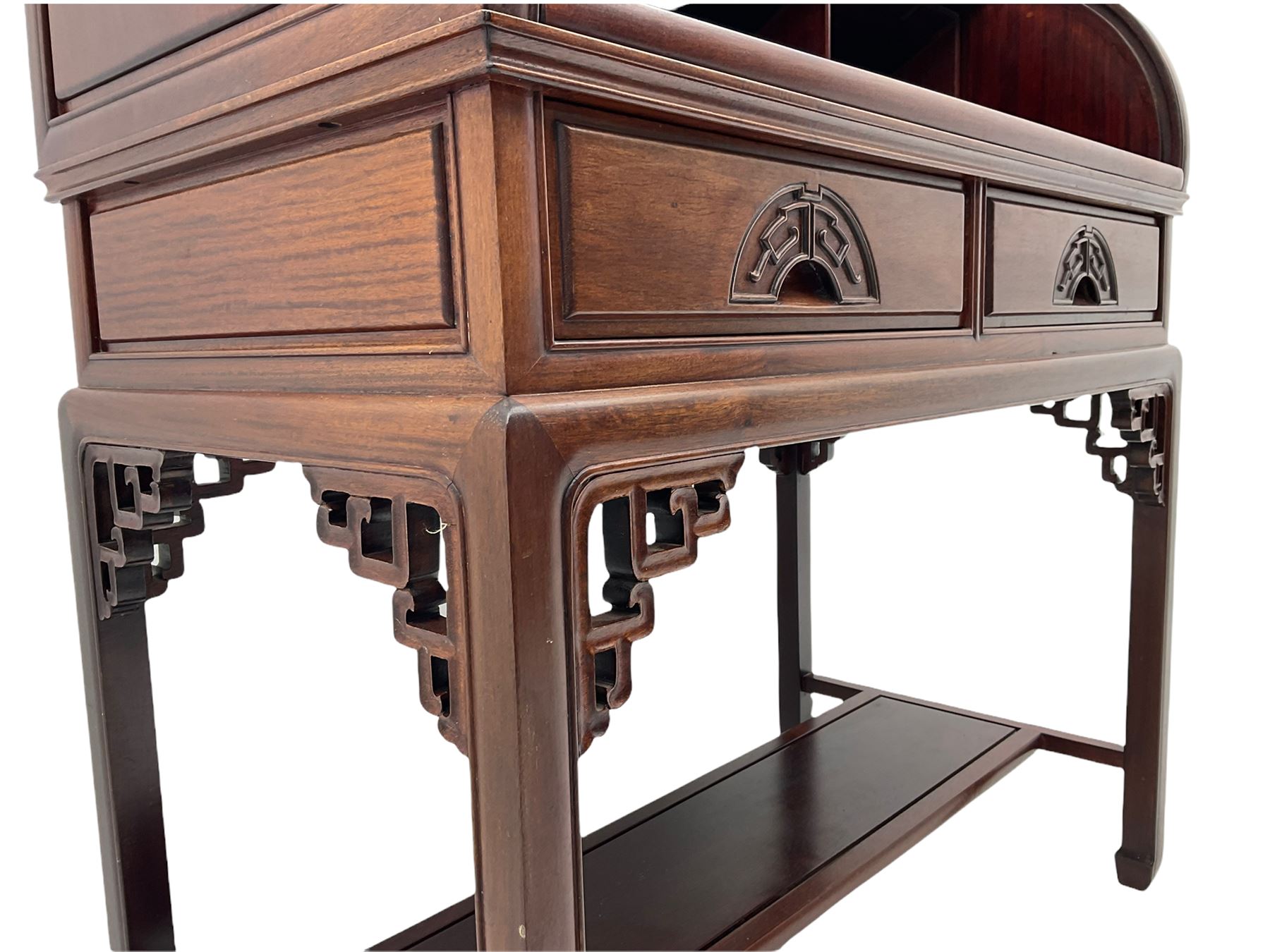 Hardwood cylinder desk, three drawers raised over curved lid, fitted interior with slide, the supports joined by undertier with fret work brackets 