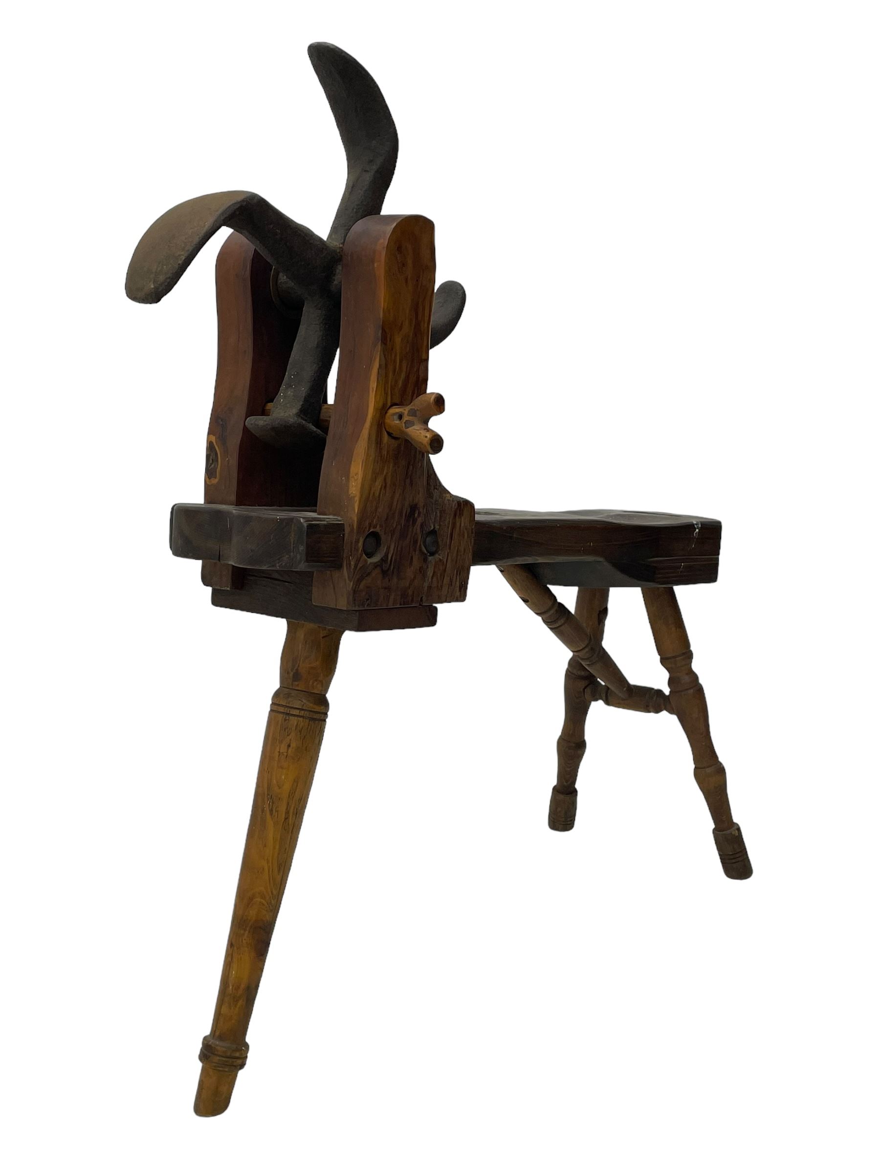 Early 19th century cobbler's work bench, in various woods, revolving cast iron last on yew wood supports, pine seat with inset maker's plaque inscribed 'No 7 Josh Blacker Harehills Leeds', on turned elm front supports and turned beech rear supports 