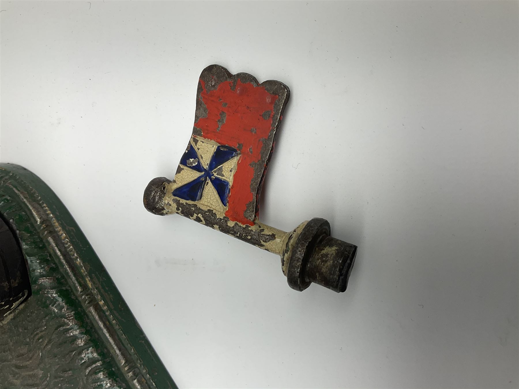 Very rare 19th century John Harper & Co. mechanical cast-iron money box, registered number 33821 patented 1885, inscribed on metal plaque 'Wimbledon Bank', based on the Queen's Trophy for shooting at Wimbledon, depicting a British Infantry man in red tunic and blue trousers lying on the ground using a gun to fire a brass coin launcher into a pill box with removable moving flag above L30cm