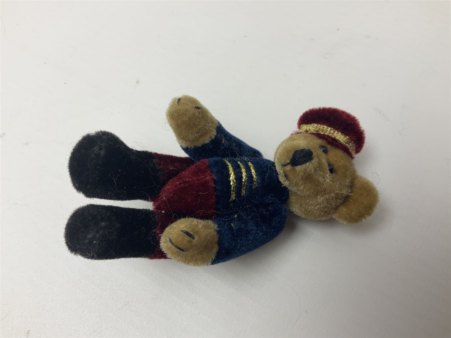 Group of five teddy bears comprising ‘George’ a unique pellet filled bear with glass eyes and velvet paws H38cm, and ‘Abbey’ a luxury German plush with wobble head and glass eyes no.5/10 H24cm, both with Teddies from Bearyland labels; along with two light blonde mohair H. M. Bears and Boyds Bears ‘T. F. Wuzzies’ no. 595140 (5)