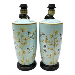 Pair of ceramic table lights, depicting birds and floral spay on a light blue ground, on a wooden plinth, H43cm. 