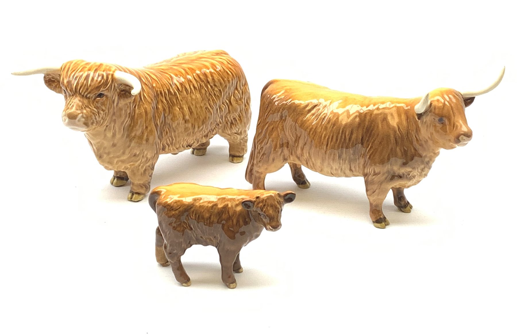 A Beswick Highland Bull, Highland Cow, and Highland Calf, each with printed mark beneath. 