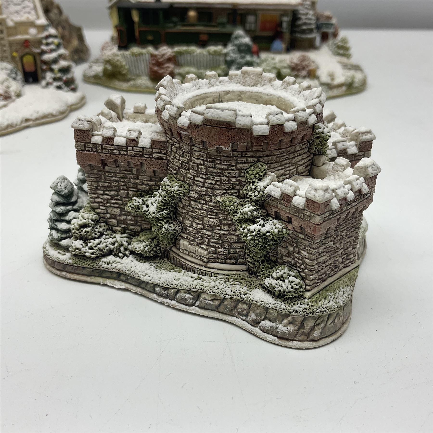 Five Lilliput Lanes, comprising Christmas at Woody Bay Station and Calling Home for Christmas both from the Illuminated collection, Castle of the Exiled Prince, Castle of The Ransomed King and Helvellyn, all with original boxes (5)