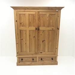  Solid pine double wardrobe, projecting cornice, two doors enclosing hanging rail above two drawers, plinth base, W146cm, H181cm, D63cm and   