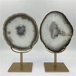Pair of white agate slices, polished with rough edges raised upon gilt metal stands, H24cm