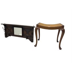 Early 20th century oak coat rack, bevelled centre mirror with flanked panels with beaded design; and mahogany stool, cane work seat raised on cabriole supports with pad feet (2)