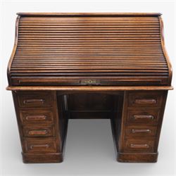 Globe Wernicke - Oak roll top desk, tambour roll top enclosing a fitted interior, raised on two pedestal bases with fitted drawers, raised on a plinth base 