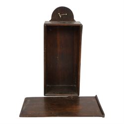 Three George III and later oak candle boxes, the first example of tapering form with shaped and pierced scroll crest, above a hinged lid, H50.5cm W18cm D13cm, the second of plain rectangular form with tapering crest, above a studded leather hinged sloped lid, H46cm W15.5cm D15.5cm, and third of plain rectangular form with demi-lune crest, with lift up front, H42.5cm W17.5cm D12cm 
