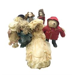 Vintage Paddington bear, with red duffle coat and hat and green Wellington boots, together with a collection of porcelain dolls, paddington H48cm 