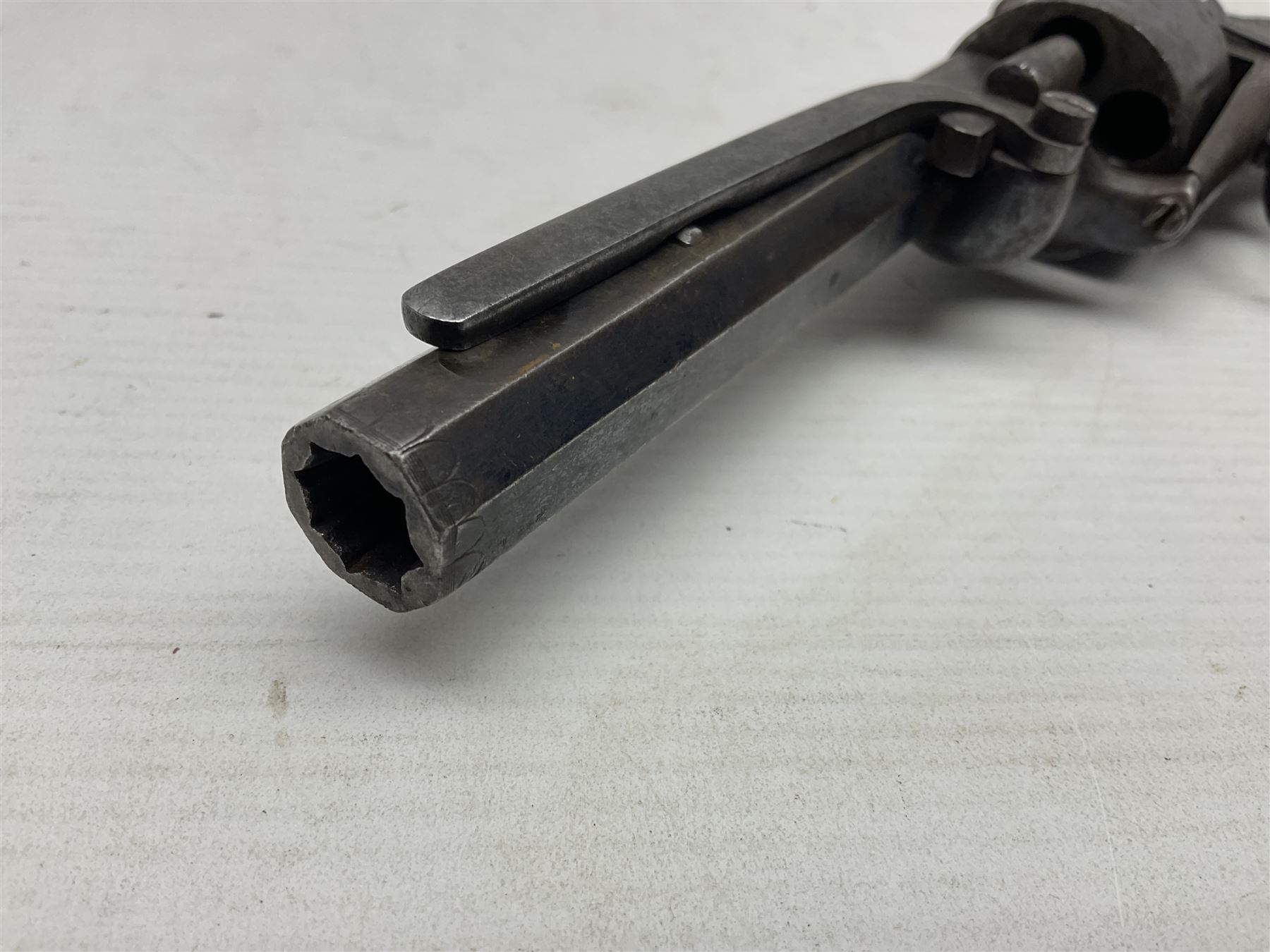 Mid-19th century Smith London .36 cal. transitional five-shot percussion revolver, the 12cm rifled octagonal barrel with side loading lever, side safety, some engraved decoration and chequered two-piece grip L28cm overall