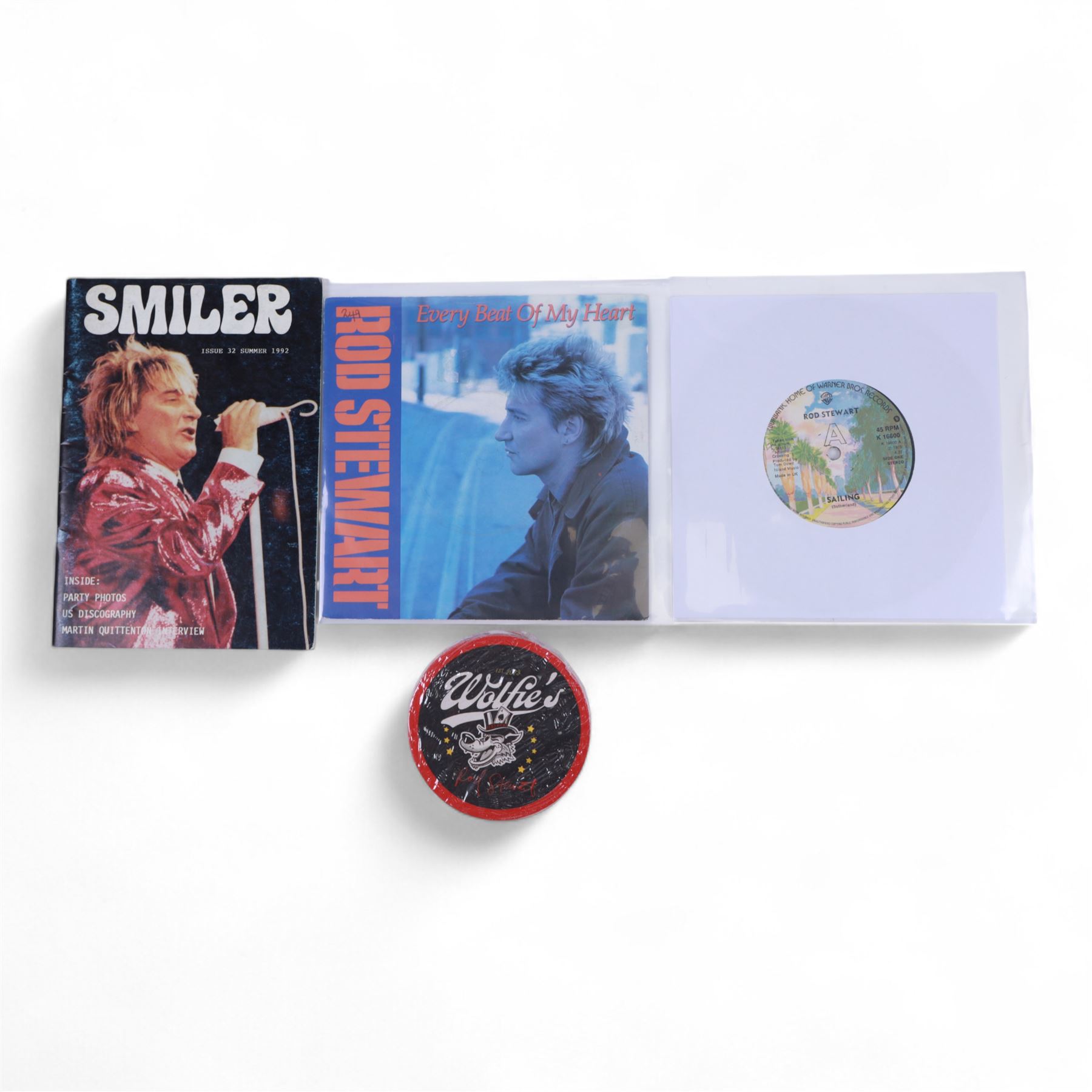 Signed bottle of Rod Stewart edition Wolfie's blended scotch whisky, together with Rod Stewart memorabilia, including first edition of his autobiography, colour photograph and two 7 inch singles