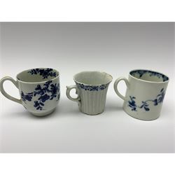 Three 18th century Worcester coffee cups, the first example of reeded form with lobed feet and scrolling handle, circa 1754, with workman's mark beneath, H5cm, the second example decorated in the Prunus root pattern, H6cm, and the third example decorated in the Mansfield pattern, with crescent mark beneath, H6cm 