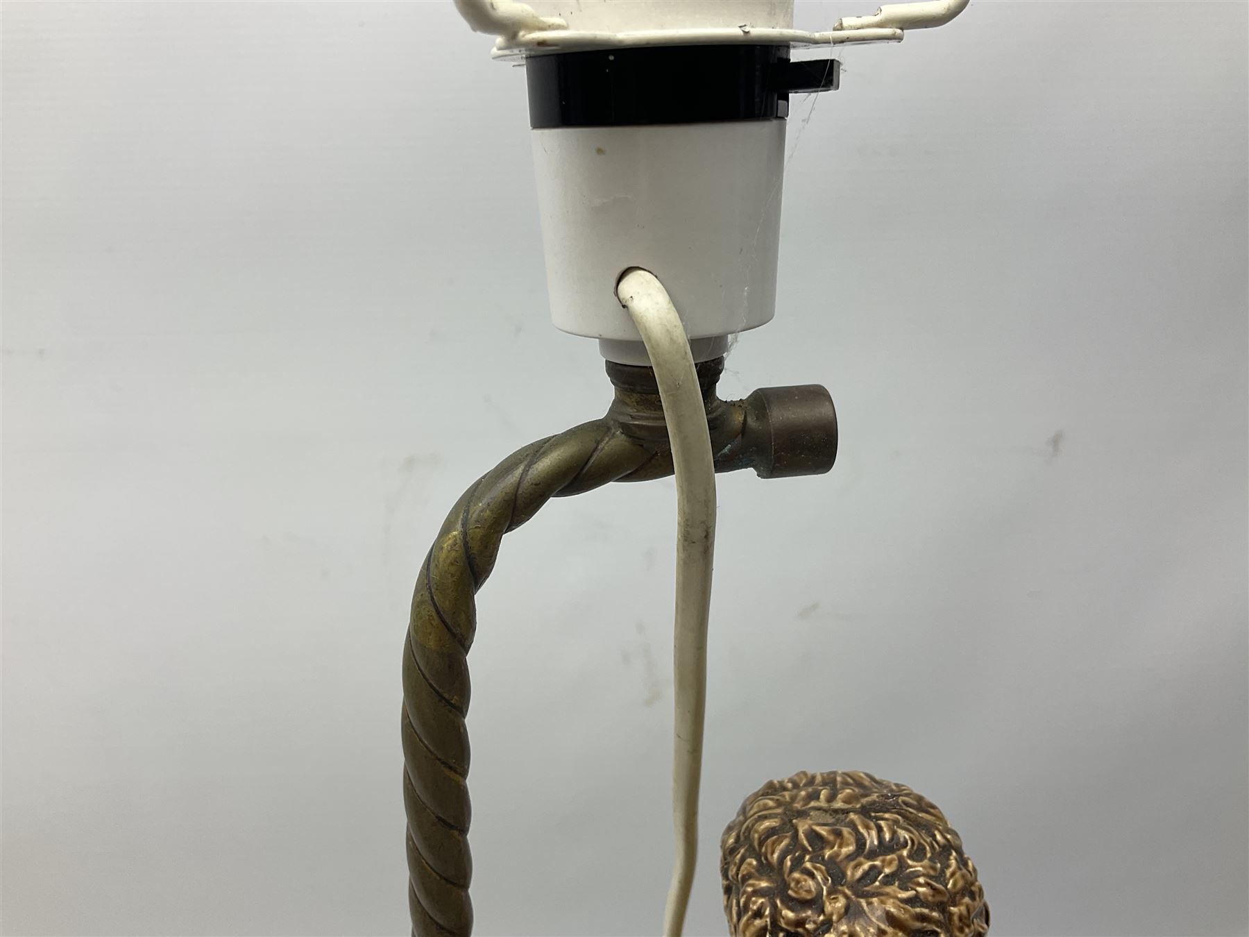 Composite table lamp modelled as a Roman Emperor donning blue robes, upon quatrefoil base modelled with rams heads and winged cherubs, H56cm excl fitting