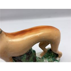 Staffordshire style figure of a greyhound beside a dead rabbit, H25cm