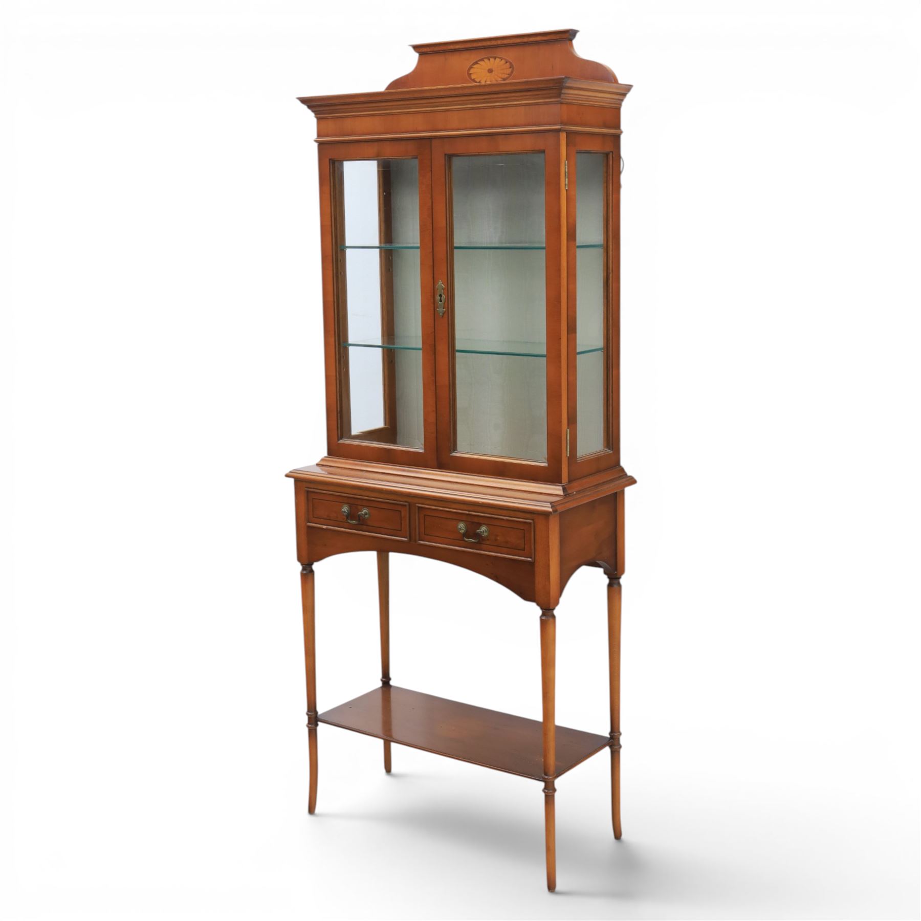 Sheraton design yew wood cabinet on stand, fitted with two glazed doors and two drawers, with lower shelf, illuminated interior