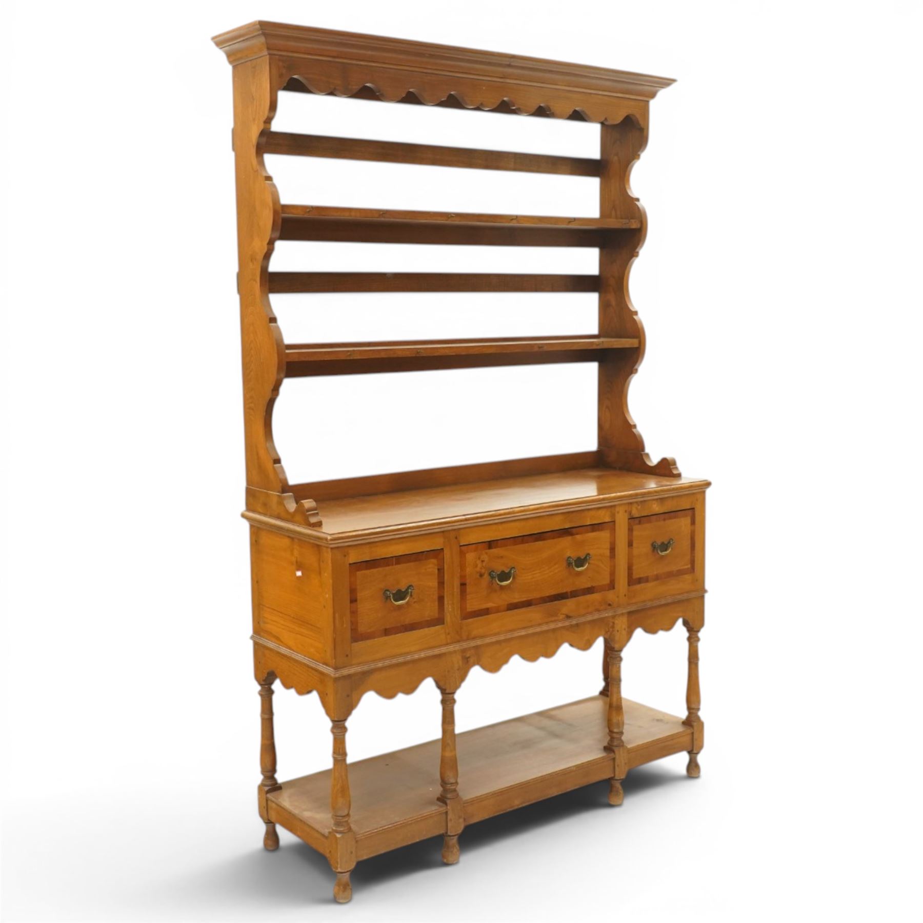 Georgian design elm dresser with plate rack, the two-tier rack with shaped frieze and hooks, over a rectangular top, fitted with three yew-wood banded drawers, shaped apron over turned supports united by undertier