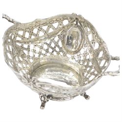 Late 19th/early 20th century German Hanau silver basket, modelled in George II style, of shaped openwork lattice form with twin handles, the body decorated with two portrait roundels and husk and ribbon swags, upon four scroll feet, with unattributed pseudo Hanau marks, and hallmarked John George Piddington, London import 1901, including handles H7cm W15cm

