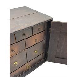 18th century oak spice cupboard, single panelled door enclosing eight drawers of various sizes, reed moulded front edges