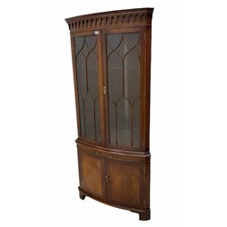 Bevan Funnell 'Reprodux' Georgian style figured mahogany bow front double corner display cabinet, two glazed doors above drinks slide and two cross-banded doors