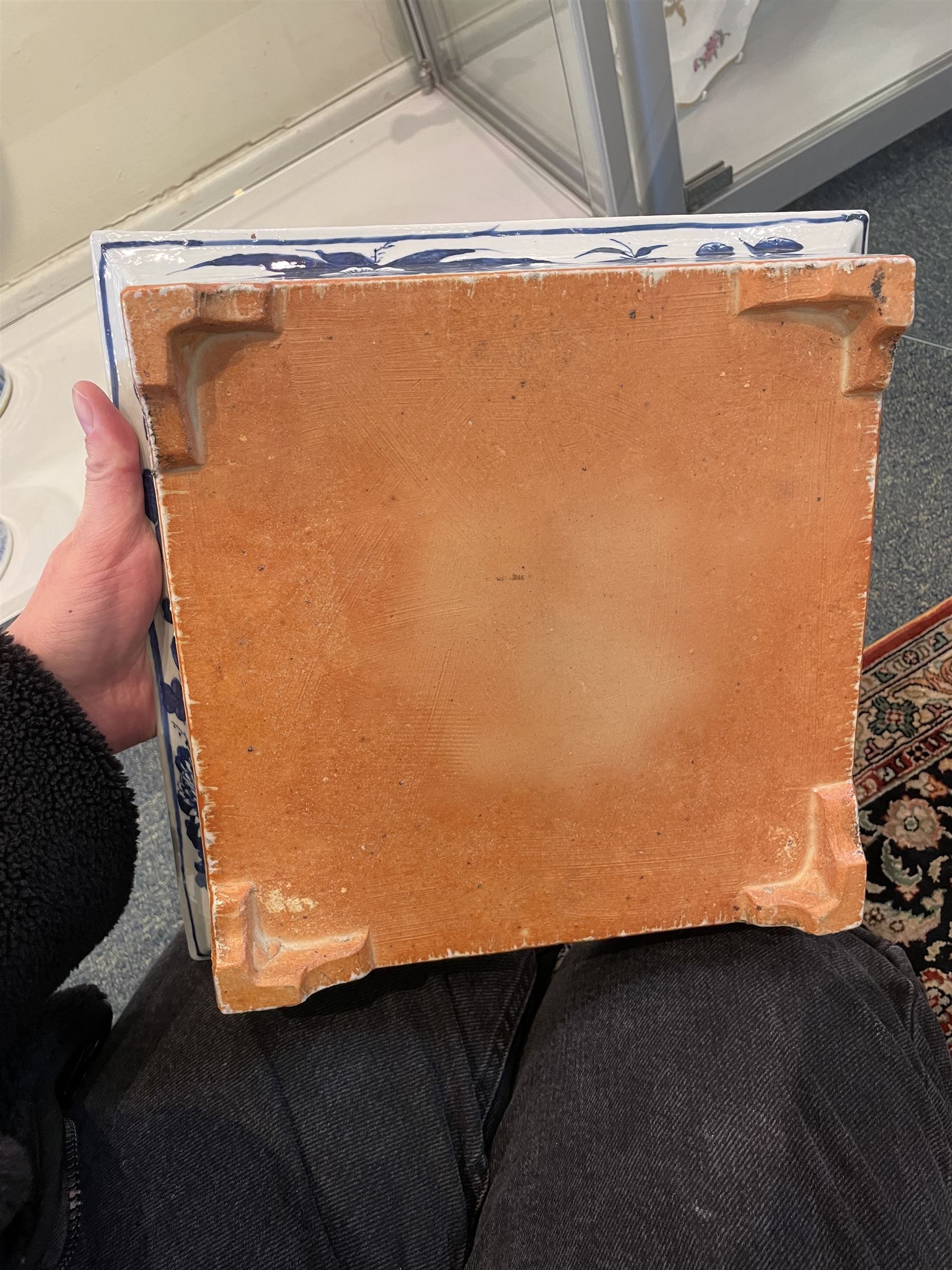 Chinese blue and white planter and stand, each of square slightly tapering and flared form, the planter decorated with two dragons and blossoming peonies, between stylised borders, the stand decorated with flower heads and vines, planter H30cm W29cm, stand H7cm D28.5cm