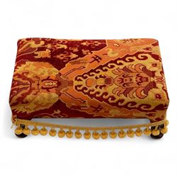 20th century Georgian style upholstered wingback armchair with footstool, the chair in yellow and red plaid fabric, the stool with fringed tapestry cover