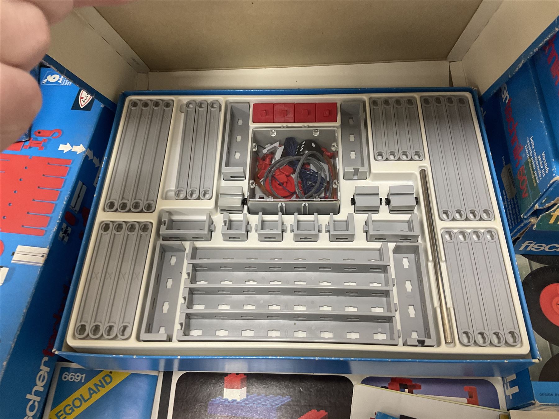 Fischer Technik/Lego/Playmobil - thirteen model building sets comprising eight Fischer Technik sets 50, 50/1, 50v, 50/2, 50+mot1 and two 50S, 50/1 add-on pack, with spare parts packs 01, 03, 05, two 22 and 30; two Lego sets comprising C107 and Lego Systems 103, part-set 870 and 970; Playmobil no.3520 set; four boxes of loose lego, various instruction manuals and a scrapbook 
