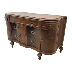 Late 20th century Italian walnut sideboard, serpentine front and bow-shaped top with highly figured veneer, single checkered-pattern frieze drawer over two drawers with central foliage cartouche, flanked by hinged frieze drawers over cupboards, on turned and carved supports